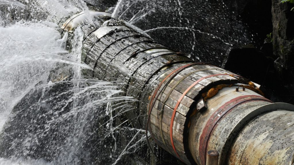 A leaking water pipe illustrating the issue of aging water infrastructure